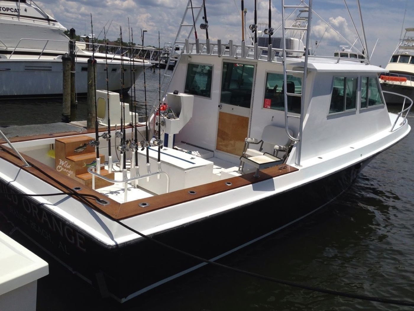The Wild Orange in her slip at Zeke's Landing — name on the transom, rods racked and ready