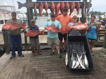 Kids with red snapper on the dock